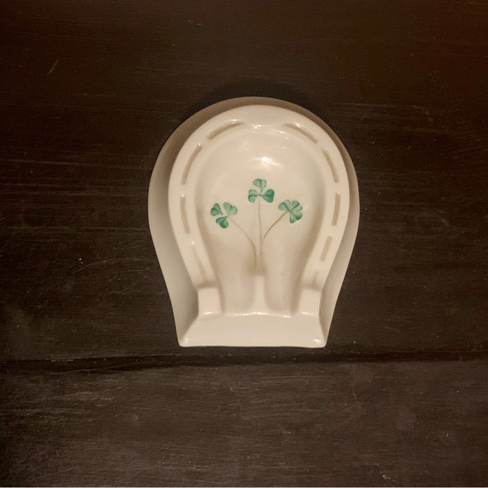 This is a Belleek Pottery Ireland porcelain horseshoe ashtray
